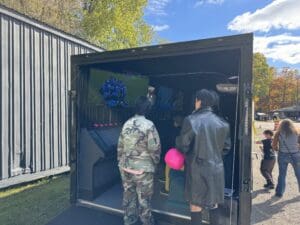 A couple of people standing in front of a storage container.