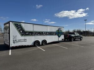 A large white trailer parked in the parking lot.