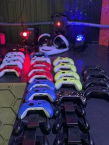 A bunch of different colored controllers are lined up